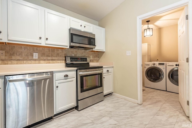 kitchen with tasteful backsplash, light countertops, washer and dryer, marble finish floor, and stainless steel appliances