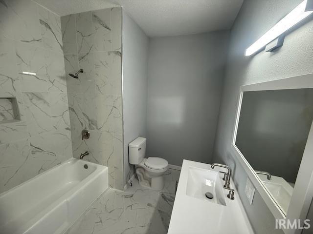 full bath with vanity, toilet, marble finish floor, and shower / bath combination