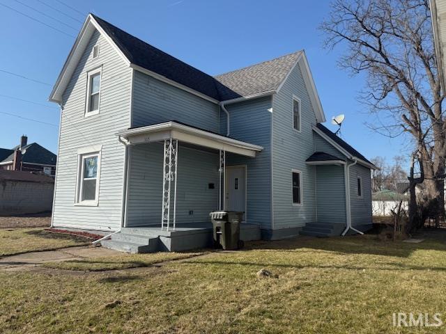 back of house featuring a lawn