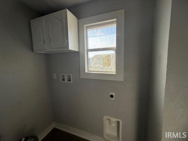 clothes washing area featuring washer hookup, cabinet space, baseboards, and hookup for an electric dryer