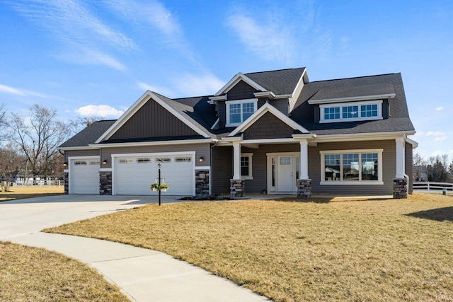 craftsman-style home with a garage, concrete driveway, a front yard, and fence