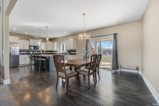 dining room featuring recessed lighting, a chandelier, baseboards, and dark wood finished floors