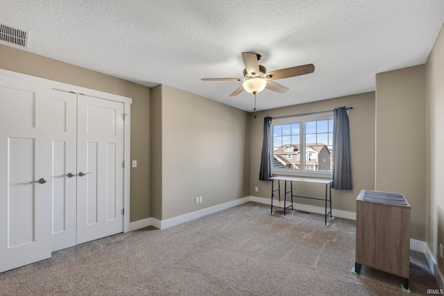 interior space with a closet, baseboards, visible vents, and carpet floors