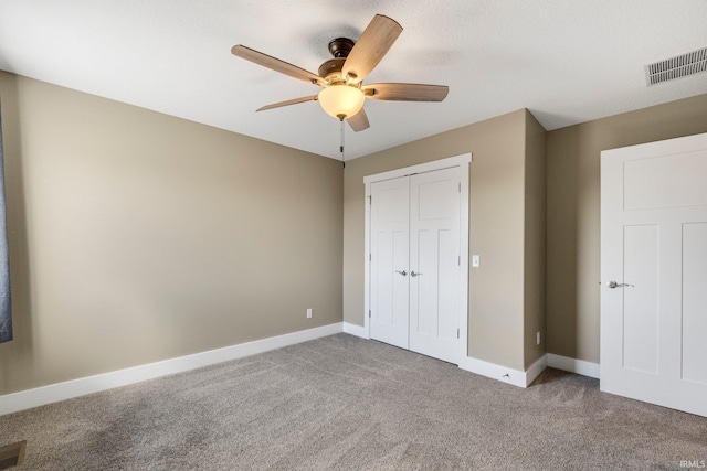 unfurnished bedroom featuring a closet, visible vents, baseboards, and carpet floors