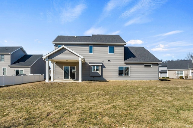 back of house with a lawn and fence