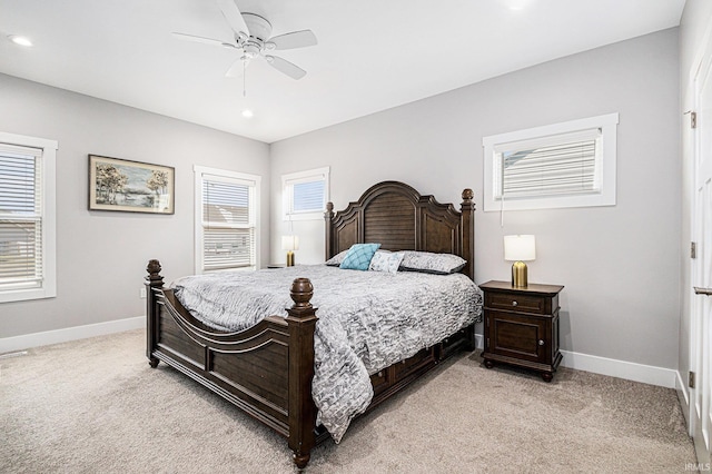 bedroom featuring recessed lighting, light colored carpet, baseboards, and ceiling fan