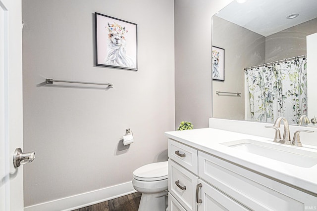 bathroom featuring vanity, a shower with curtain, wood finished floors, baseboards, and toilet