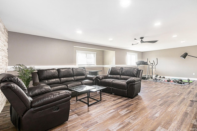 living room featuring a ceiling fan, recessed lighting, wood finished floors, and baseboards