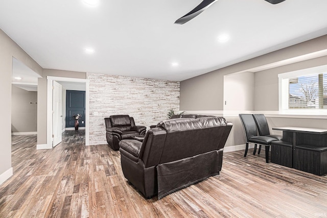 living room featuring ceiling fan, baseboards, wood finished floors, and recessed lighting