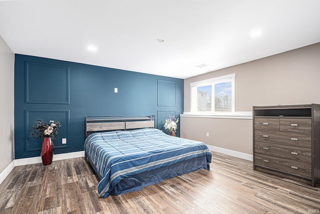 bedroom featuring recessed lighting, wood finished floors, and baseboards