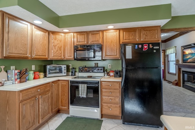 kitchen featuring black appliances, a textured ceiling, a toaster, light countertops, and light tile patterned floors