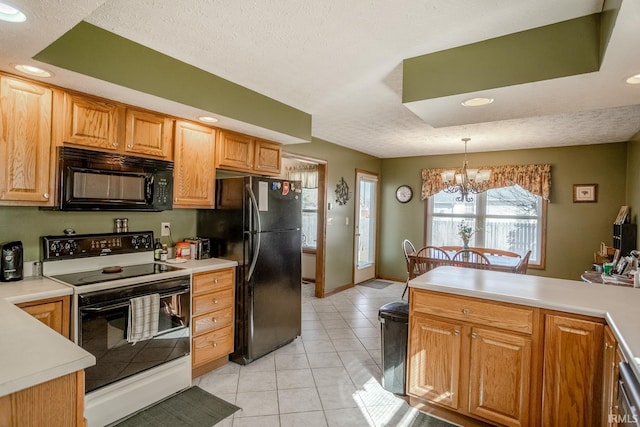 kitchen with an inviting chandelier, black appliances, and light countertops