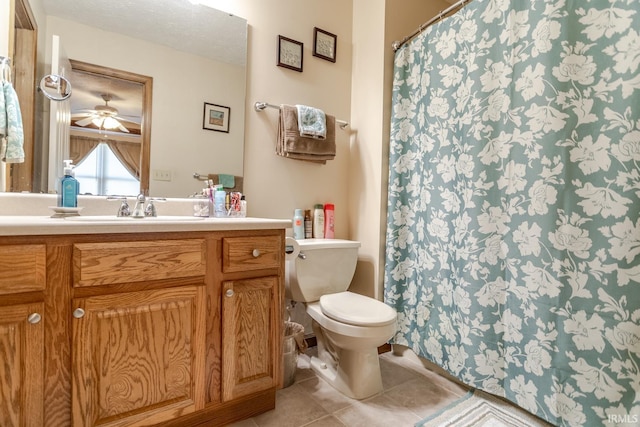 full bathroom featuring a shower with curtain, toilet, a textured ceiling, tile patterned flooring, and vanity