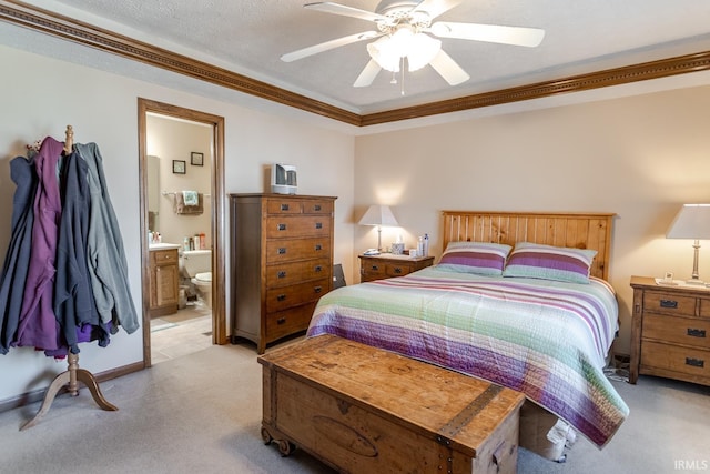 bedroom featuring ceiling fan, ornamental molding, ensuite bathroom, a textured ceiling, and light carpet