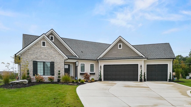 craftsman inspired home with a front lawn, roof with shingles, a garage, stone siding, and driveway