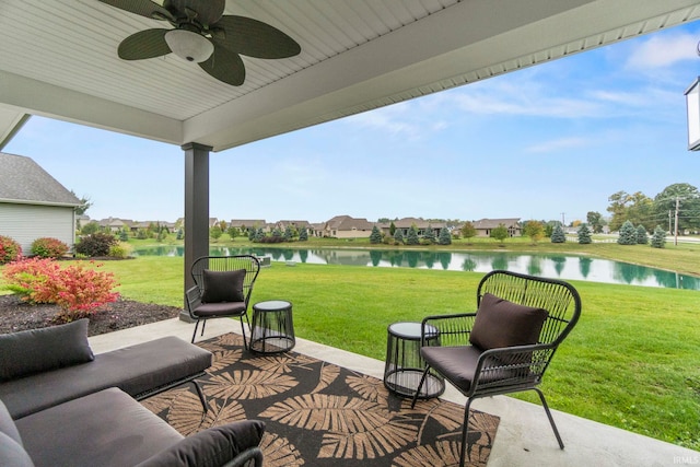 view of patio / terrace with a ceiling fan and a water view