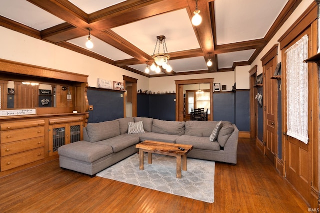 living room with a notable chandelier, beamed ceiling, coffered ceiling, and wood finished floors