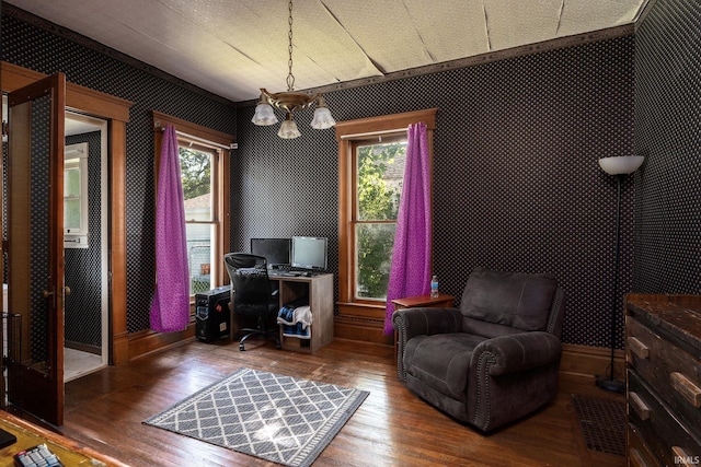 office featuring a chandelier, wallpapered walls, baseboards, and wood-type flooring