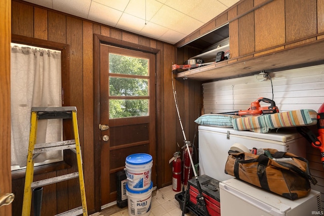 washroom with wooden walls and cabinet space