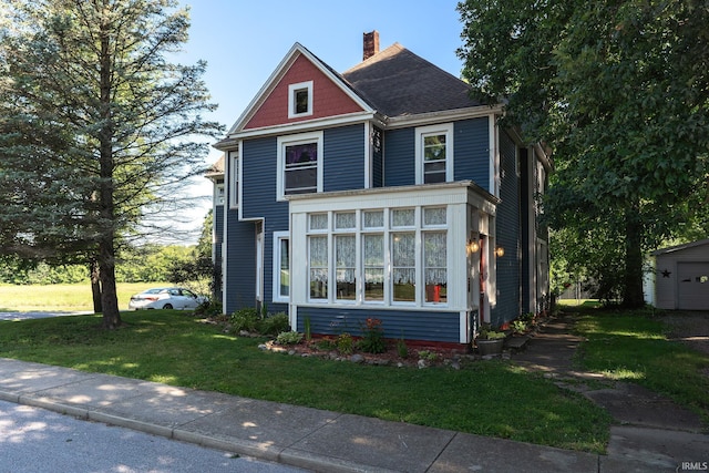 view of front of home with a front lawn and a chimney