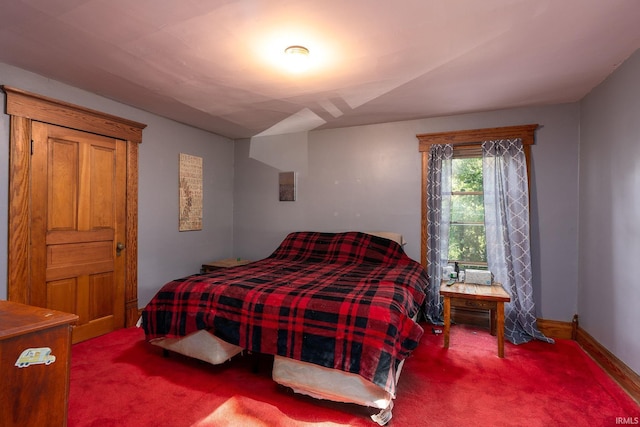 bedroom featuring baseboards and carpet flooring