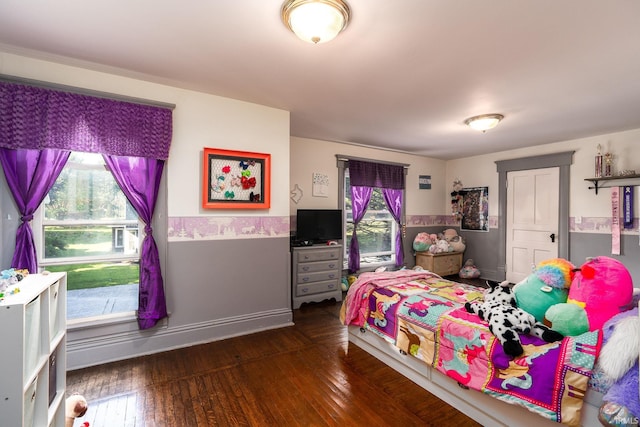 bedroom featuring baseboards and dark wood-style floors