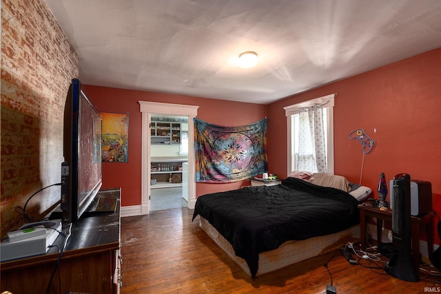 bedroom with wood finished floors and baseboards