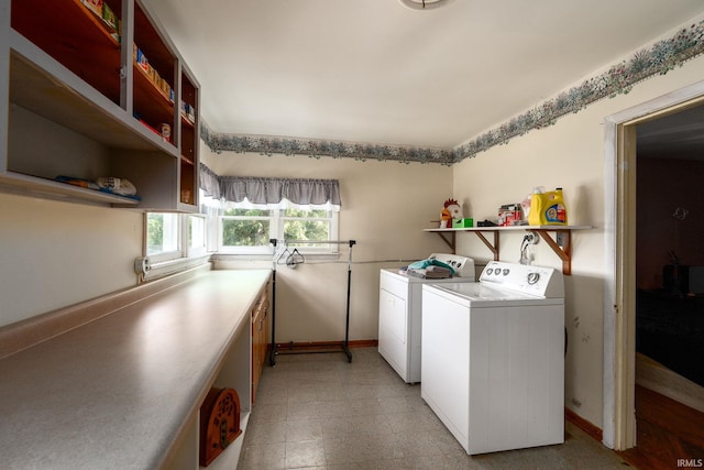 washroom featuring baseboards, independent washer and dryer, and laundry area