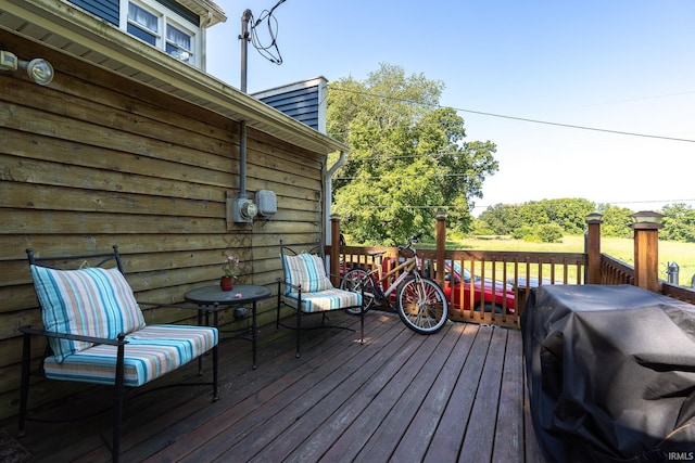 wooden deck featuring a grill