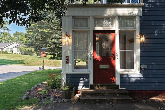 entrance to property with a lawn