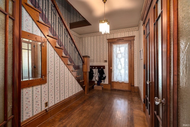 entryway with baseboards, hardwood / wood-style floors, stairs, and wallpapered walls