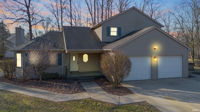 view of front facade with an attached garage, covered porch, driveway, and roof with shingles