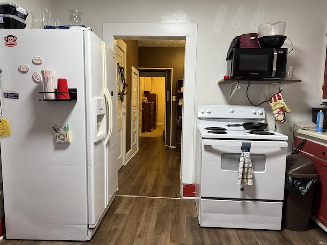 kitchen with white appliances and wood finished floors