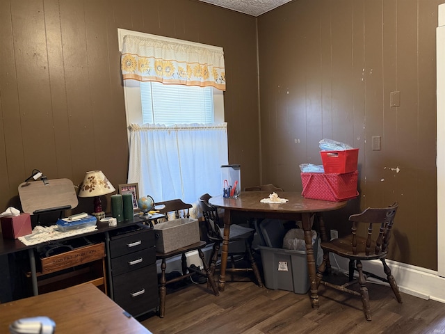 home office featuring wood walls and wood finished floors