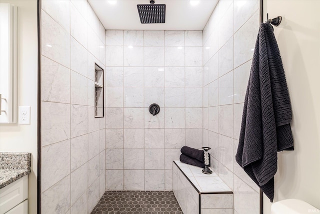 full bathroom featuring vanity and a tile shower