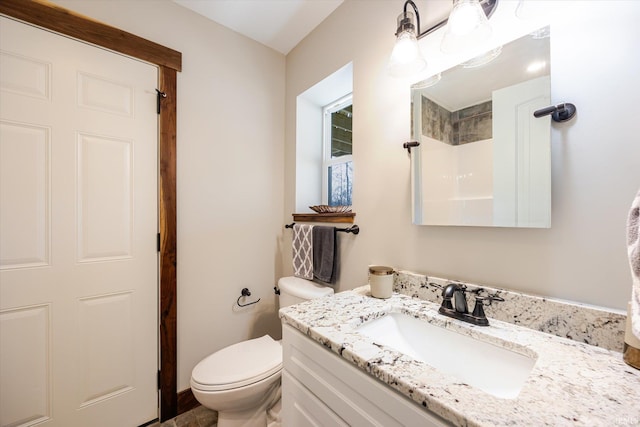 bathroom with toilet and vanity