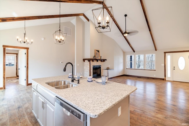 kitchen with visible vents, light wood-type flooring, a sink, dishwasher, and a chandelier