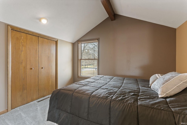 bedroom featuring a closet, carpet, and vaulted ceiling with beams