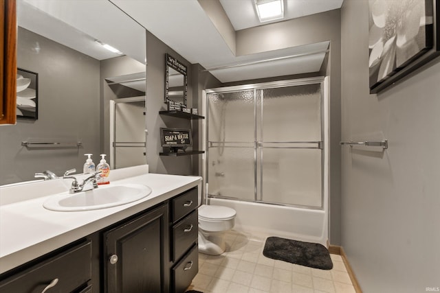 full bath with toilet, vanity, baseboards, and shower / bath combination with glass door