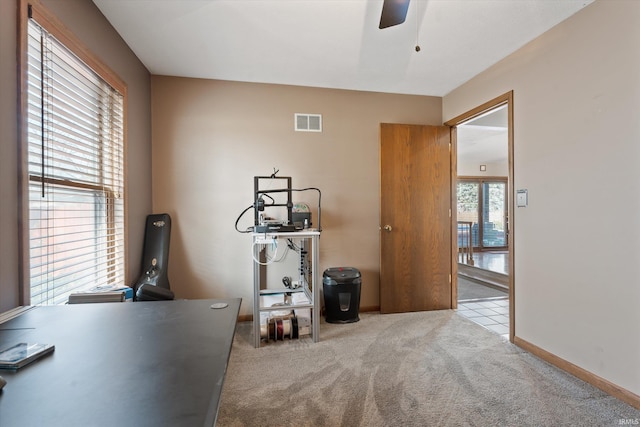 interior space featuring baseboards, visible vents, carpet floors, and ceiling fan