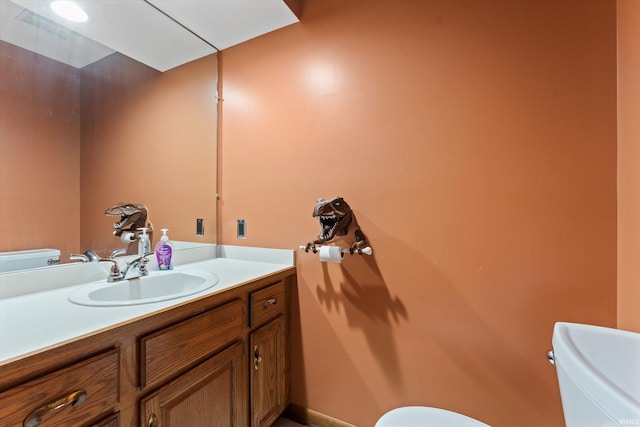 bathroom featuring toilet and vanity