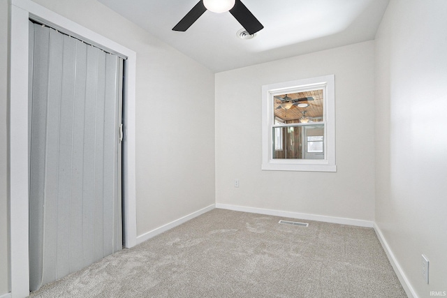 unfurnished bedroom featuring baseboards, visible vents, carpet floors, and ceiling fan