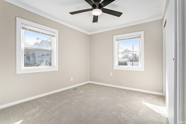 unfurnished bedroom with baseboards, carpet, visible vents, and ornamental molding