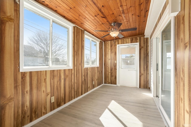 unfurnished sunroom with wooden ceiling and a ceiling fan