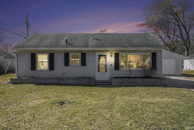 view of front of home featuring a front lawn, driveway, a garage, and roof with shingles