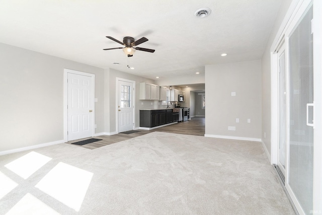 unfurnished living room featuring visible vents, baseboards, carpet flooring, recessed lighting, and a ceiling fan