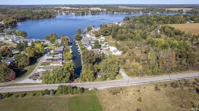 birds eye view of property with a wooded view and a water view