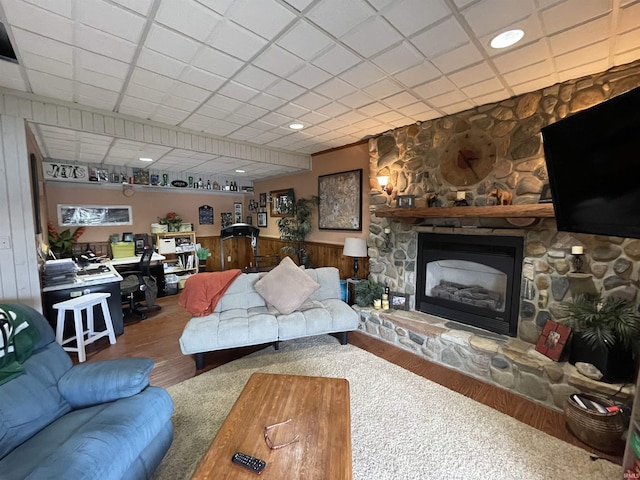 living room with a fireplace, wood finished floors, and wainscoting