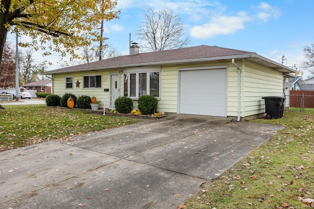 ranch-style home featuring driveway, fence, a front yard, a garage, and a chimney