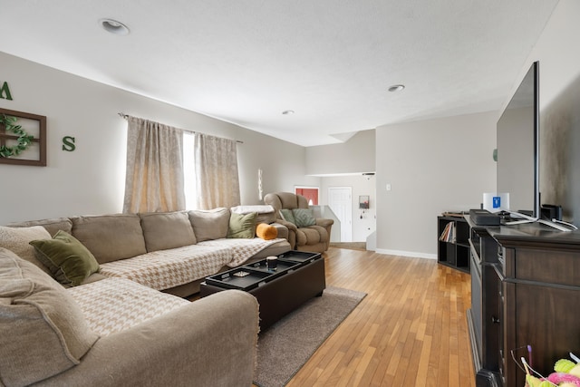 living area featuring light wood finished floors and baseboards